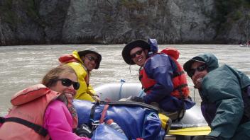 4 people on boat smiling