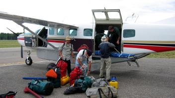 Alex, Ryan, and Dennis are loading the Cessna airplane