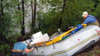 2 people steering boats