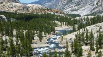 large landscape of mountain and stream in middle