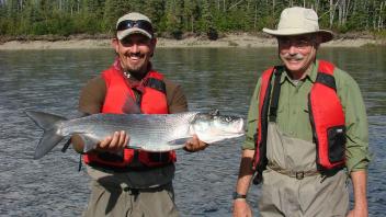 2 people holding fish