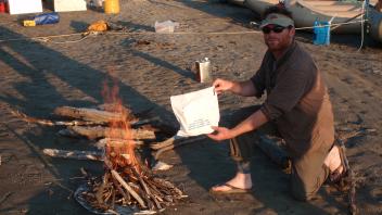 person smiling at campfire