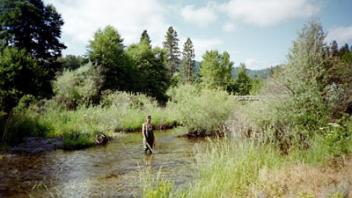 River running through meadow.