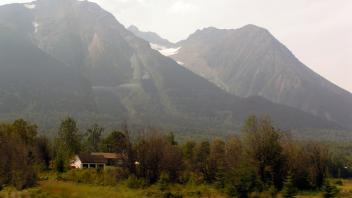 Small hay farms with glaciated mountains