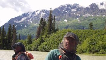 photo of two people on raft