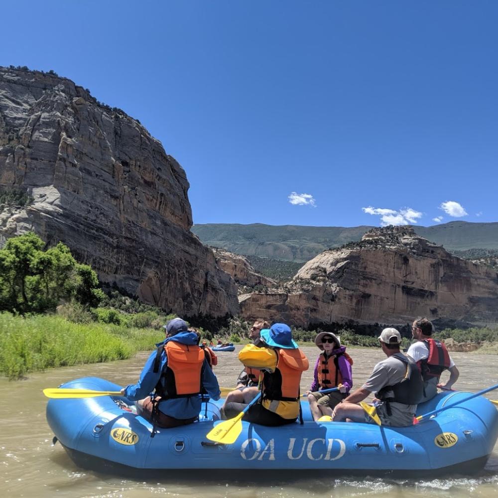 Instructor Nicholas Pinter guides a boat toward camp