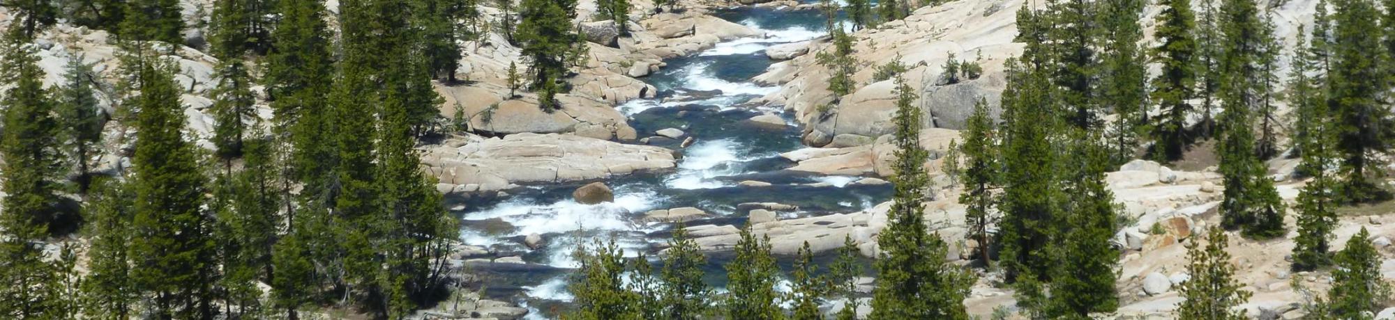 large landscape of mountain and stream in middle